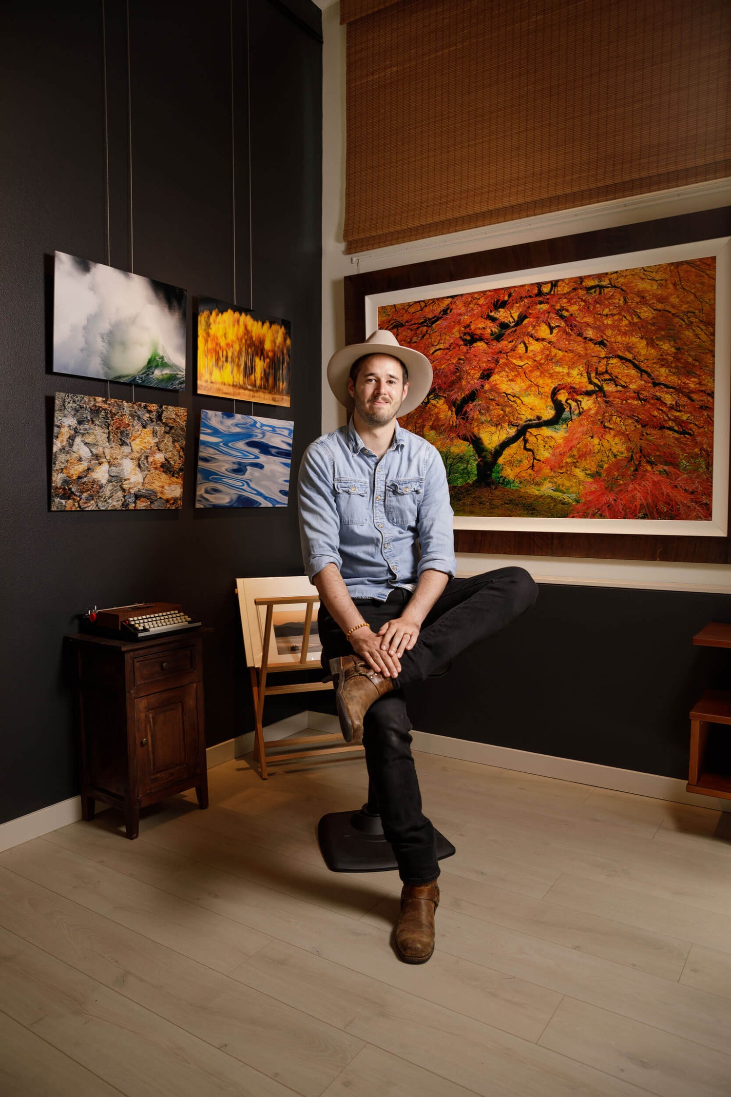 Artist Lars Gesing in his West Seattle gallery showing his large wall art photography.