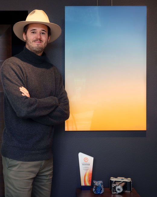 Seattle artist Lars Gesing in his West Seattle gallery with one of his artworks.