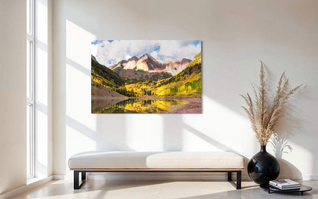 Stunning artwork of the Maroon Bells in Aspen during fall hangs in an entryway.