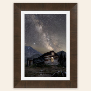 A framed piece of Colorado art shows photography of the milky way above Mayflower Gulch.