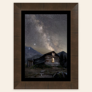 A framed piece of Colorado art shows photography of the milky way above Mayflower Gulch.