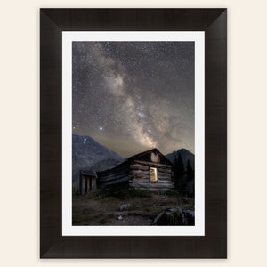 A framed piece of Colorado art shows photography of the milky way above Mayflower Gulch.