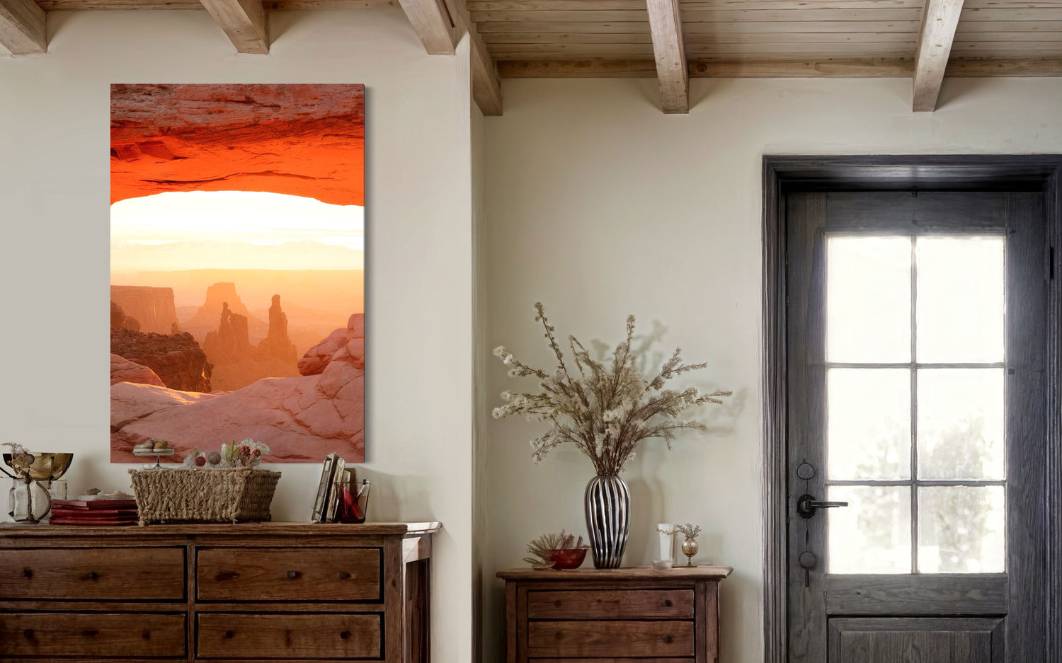 A piece of Moab art showing a Mesa Arch picture at sunrise hangs in an entryway.