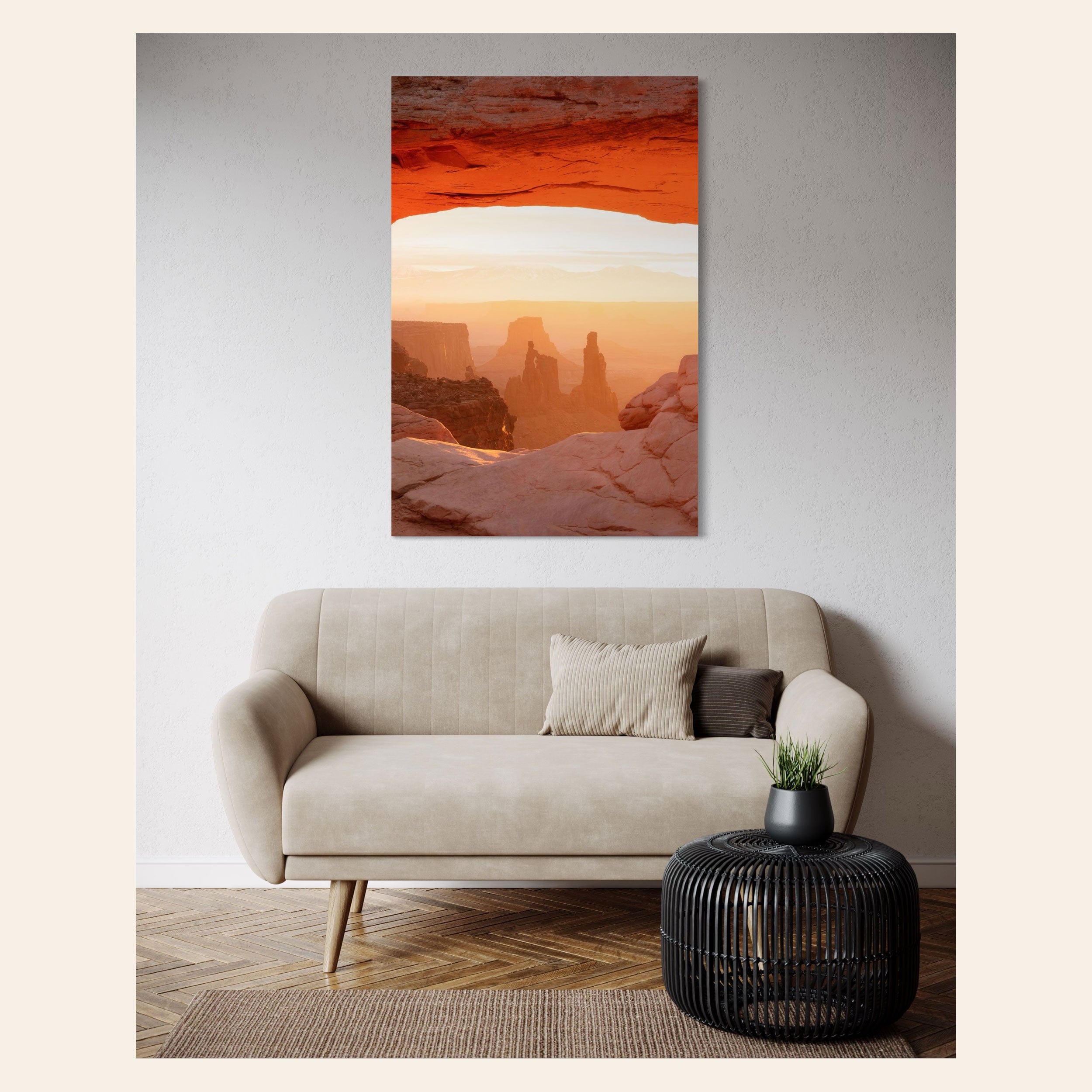 A piece of Moab art showing a Mesa Arch picture at sunrise hangs in a living room.