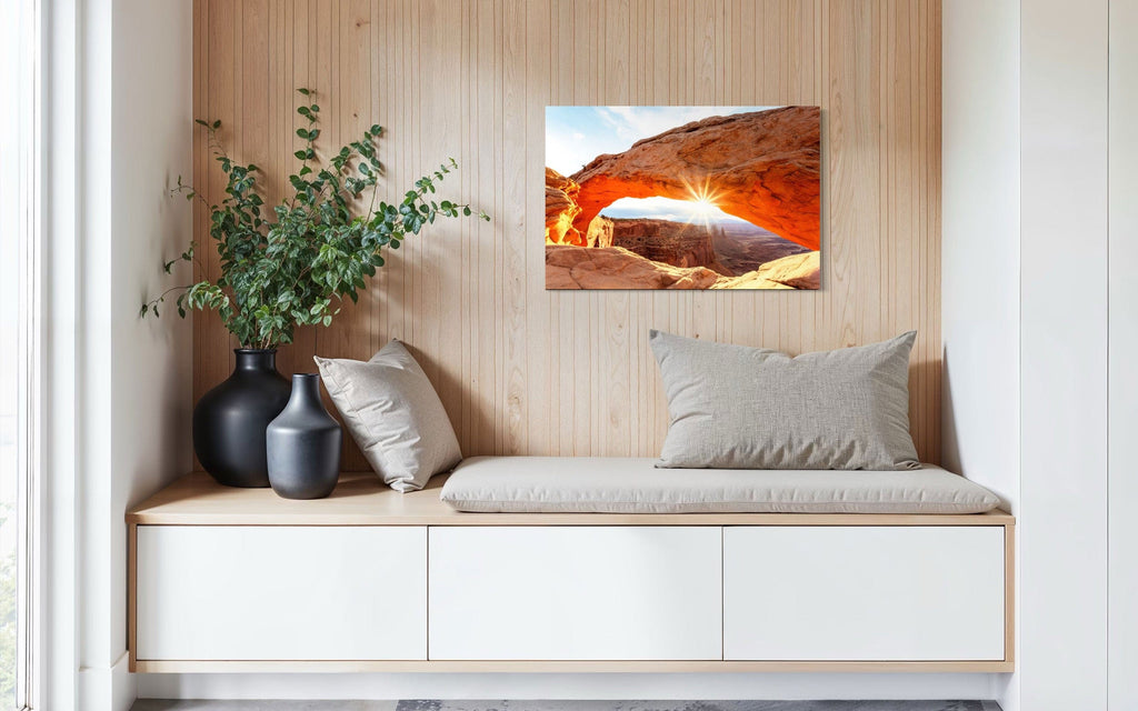 A piece of Moab art showing Mesa Arch in Canyonlands National Park hangs in a sitting area.