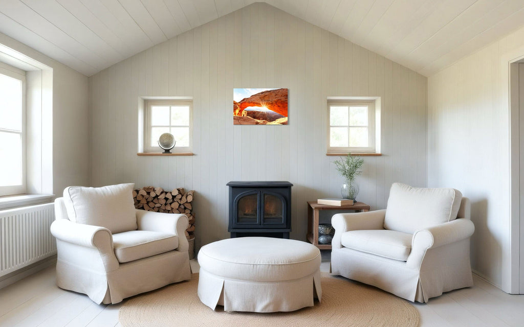 A piece of Moab art showing Mesa Arch in Canyonlands National Park hangs above a wood-burning stove.