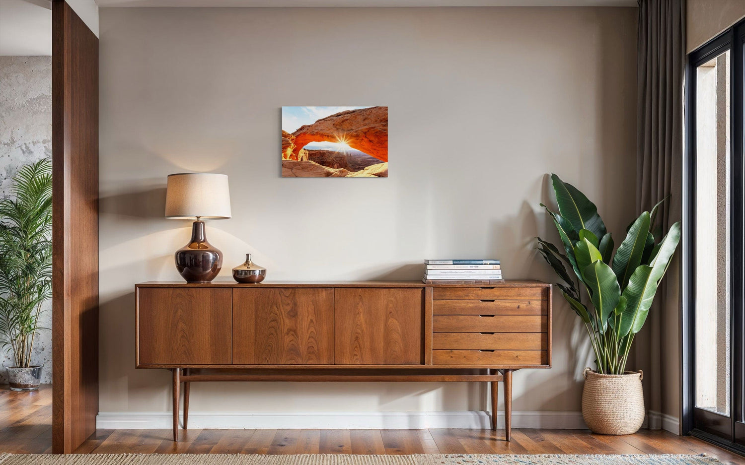 A piece of Moab art showing Mesa Arch in Canyonlands National Park hangs in a midcentury modern home.