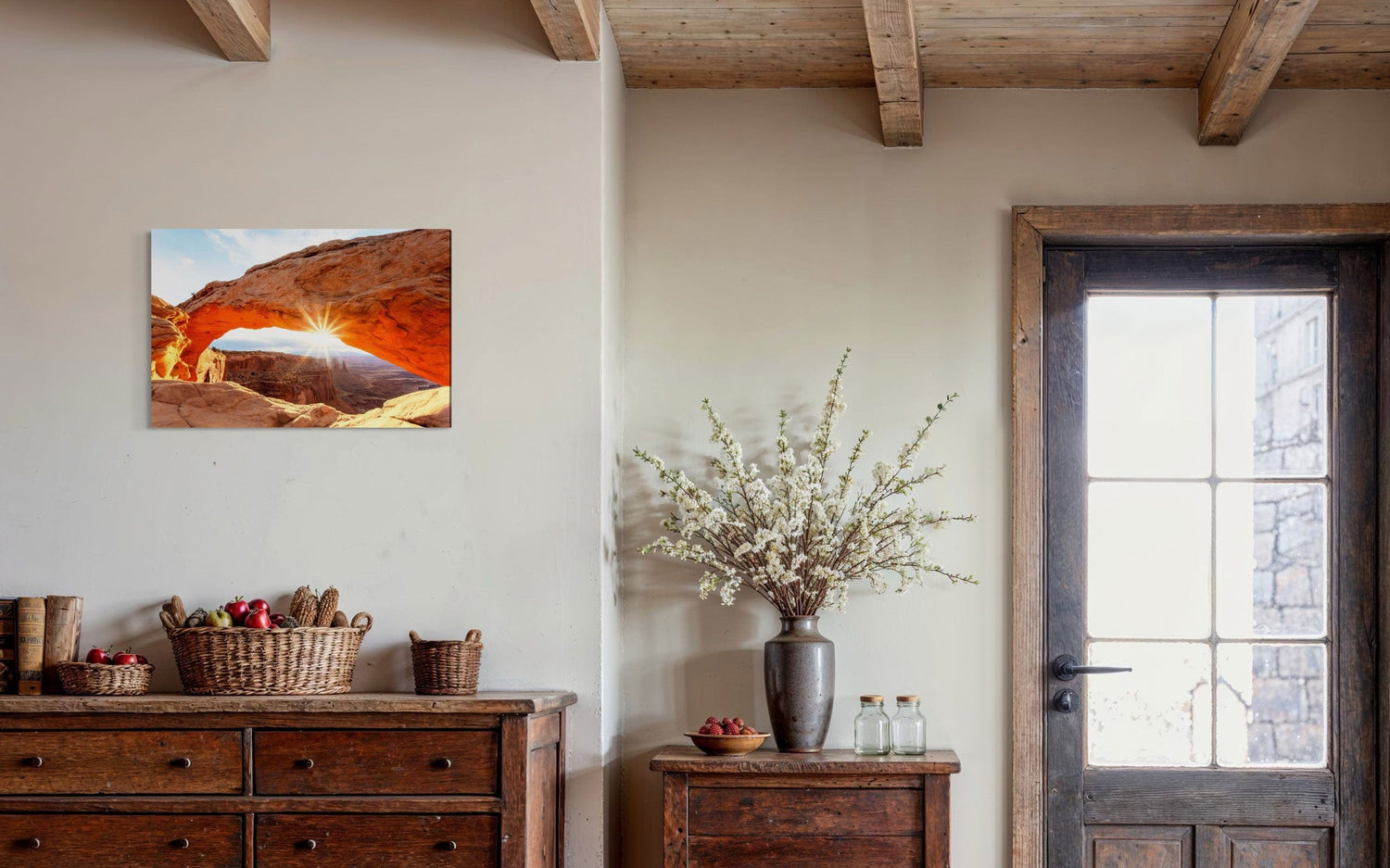 A piece of Moab art showing Mesa Arch in Canyonlands National Park hangs in an entryway.