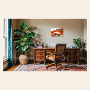 A piece of Moab art showing Mesa Arch in Canyonlands National Park hangs in an office.