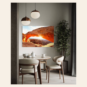 A piece of Moab art showing Mesa Arch in Canyonlands National Park hangs in a dining room.