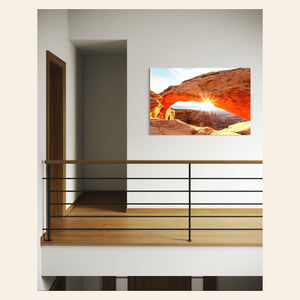 A piece of Moab art showing Mesa Arch in Canyonlands National Park hangs in a hallway.