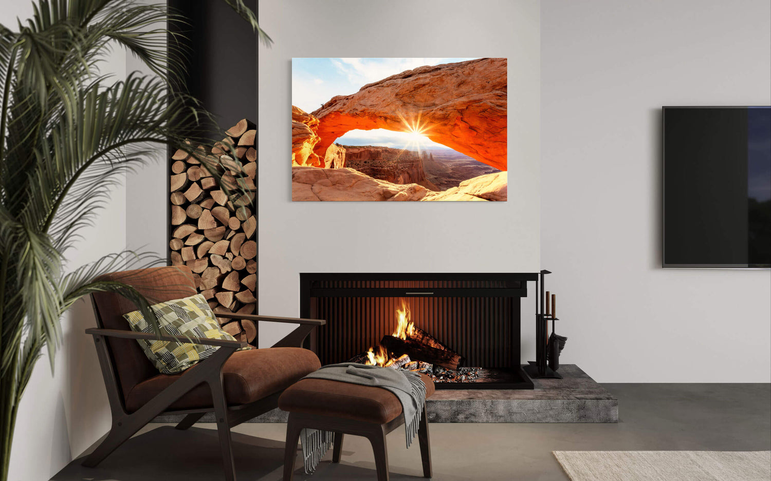 A piece of Moab art showing a Mesa Arch picture hangs in a living room.