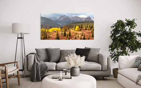 A cabin picture from Molas Pass near Silverton during peak Colorado fall hangs in a living room.