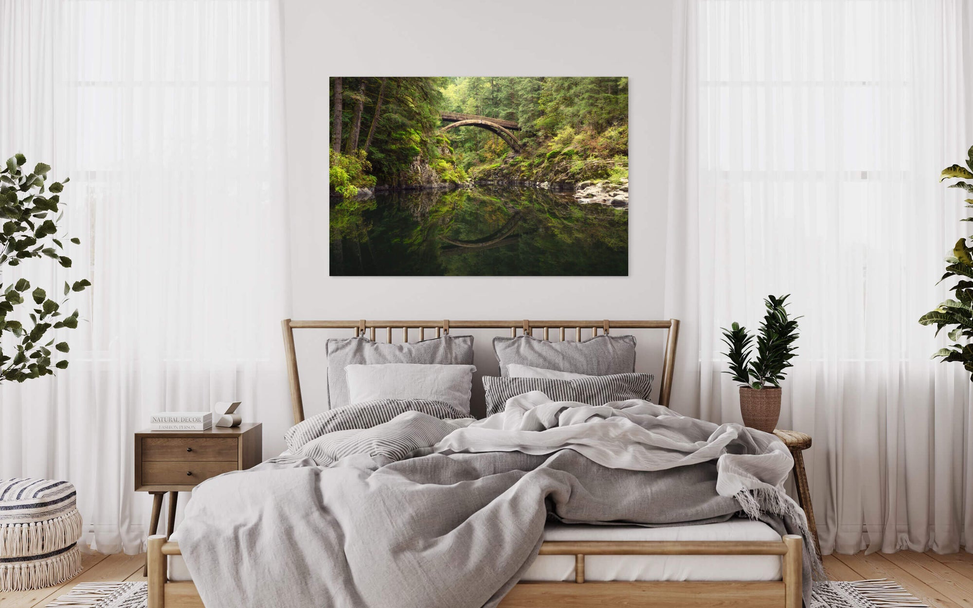 A Moulton Falls picture showing the first fall colors hangs in a bedroom.