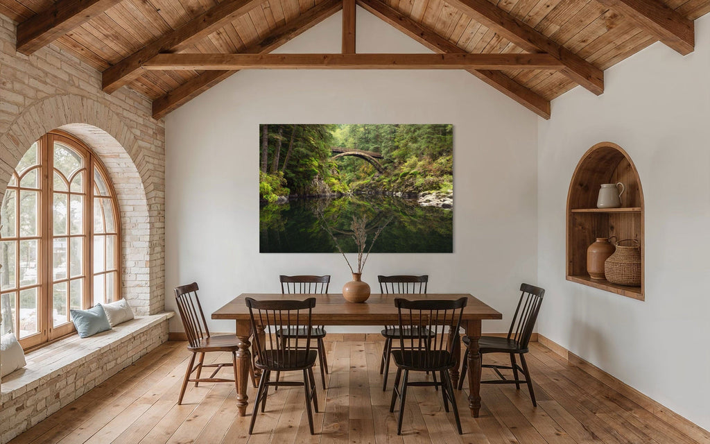 A piece of Washington art showing a Moulton Falls photo hangs in a dining room.