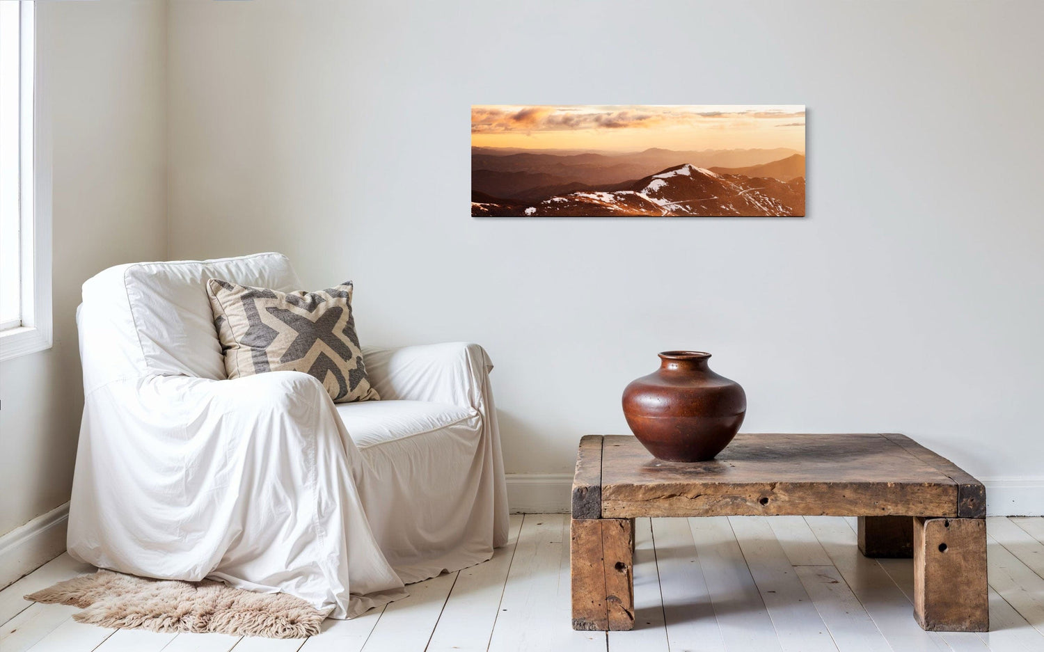 A piece of Colorado art showing a photo of Mount Evans at sunrise hangs in a seating area.