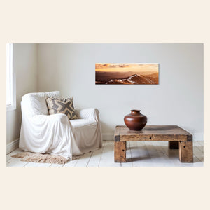 A piece of Colorado art showing a photo of Mount Evans at sunrise hangs in a sitting area.