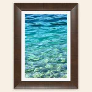 A piece of framed Mount Rainier wall art showing a lake in the national park in the morning light.