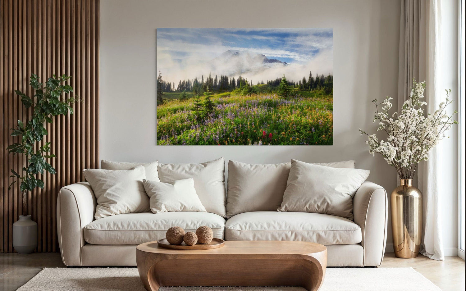A piece of Mount Rainier art showing a wildflower photo at Paradise hangs above a couch.