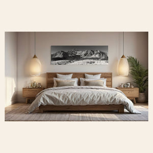 A piece of Telluride art showing a black and white photography print of Mount Wilson hangs in a bedroom.