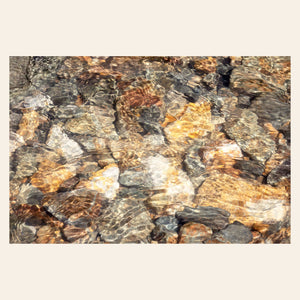 A piece of Telluride art shows a photo of a Colorado mountain stream.