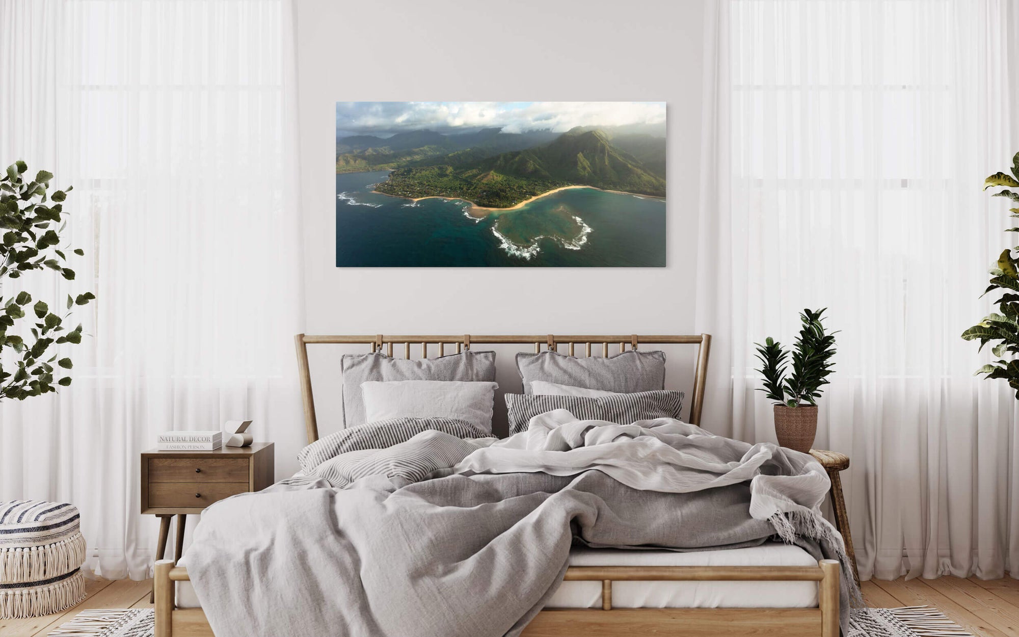 A piece of Napali Coast art showing a Ke'e Beach picture from Kauai hangs in a bedroom.