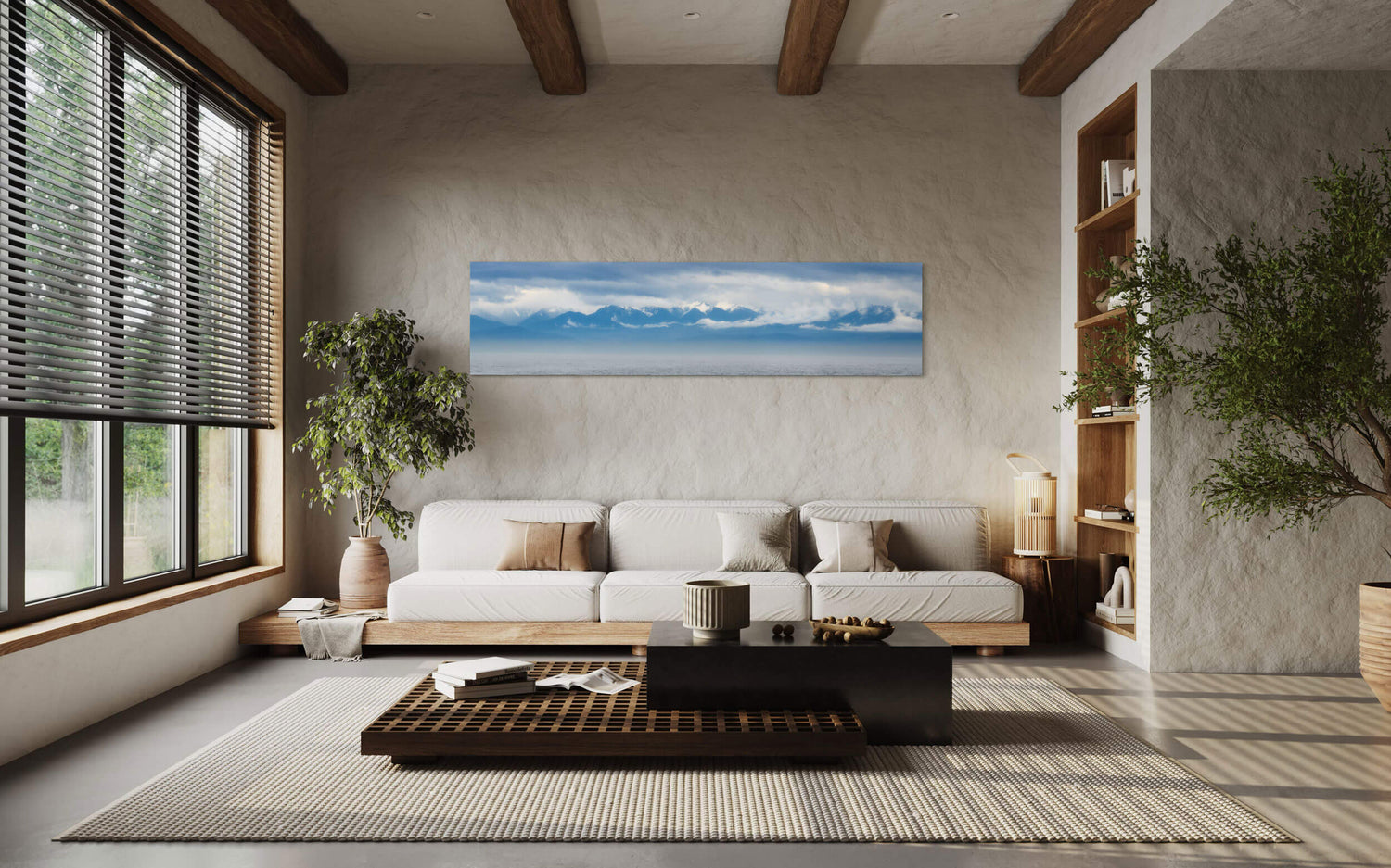An Olympic Mountains panorama photograph hangs in a living room.
