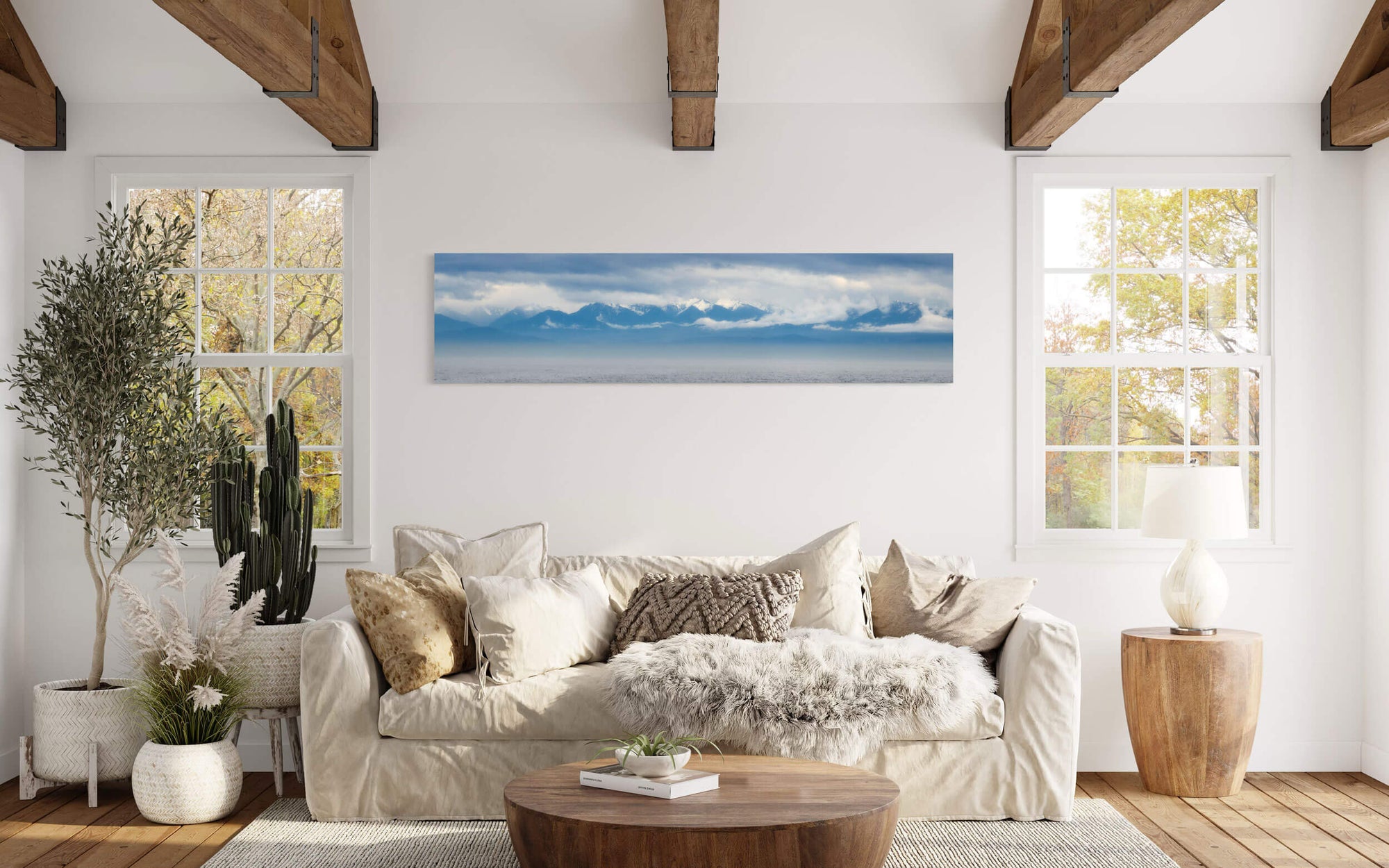 An Olympic Mountains panorama photograph hangs in a living room.