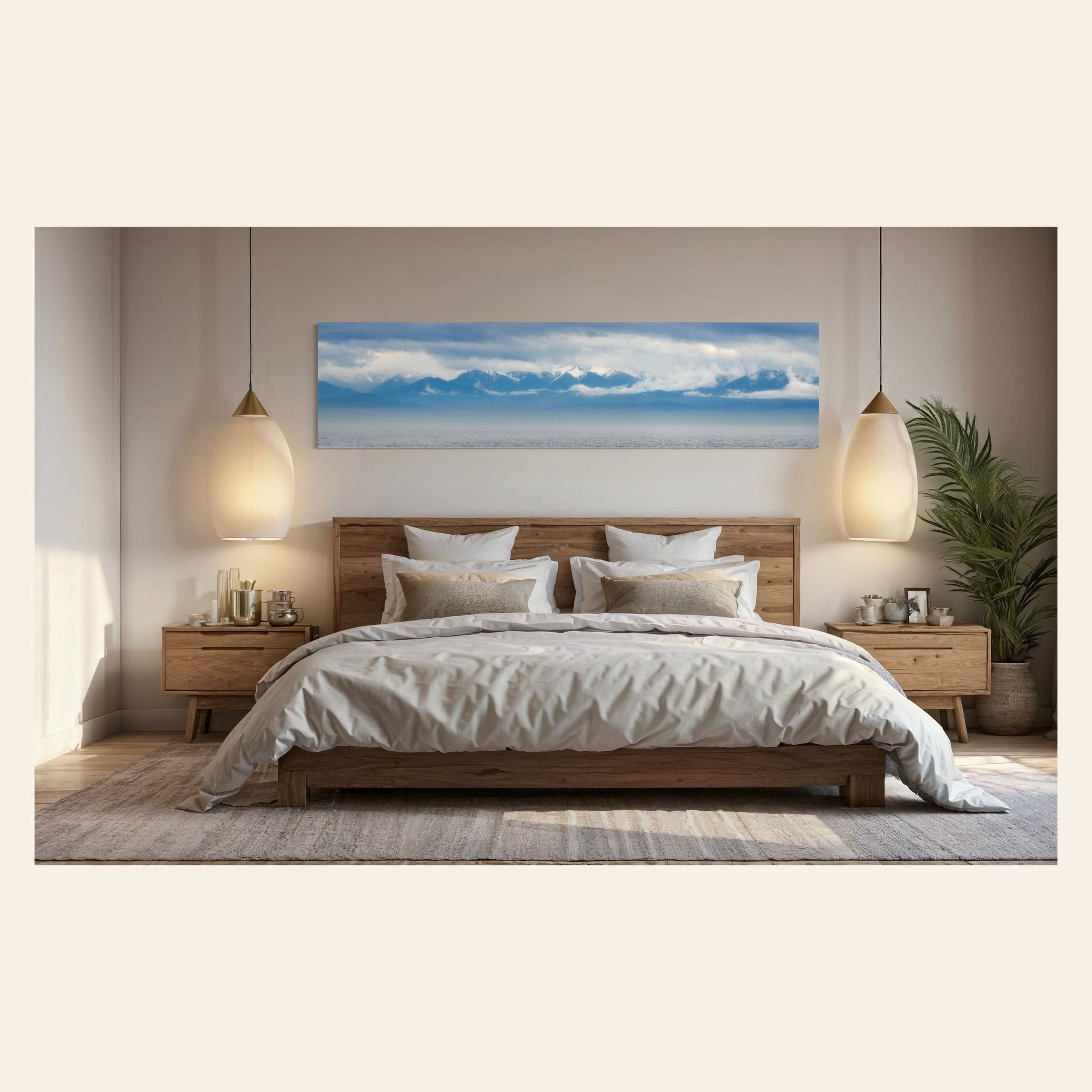 A piece of wall art showing an Olympic Mountains panorama photo hangs in a bedroom.