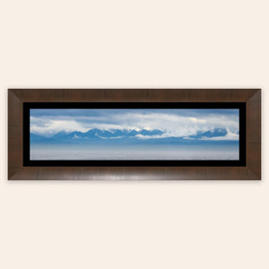 A piece of framed wall art shows an Olympic Mountains panorama photo.