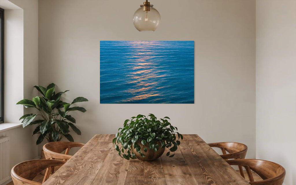 An ocean sunset photo hangs above a dining table. | Lars Gesing Fine Art | Coastal Wall Art