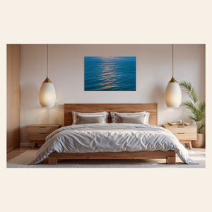 An ocean sunset photo hangs above a bed. | Lars Gesing Fine Art | Coastal Wall Art