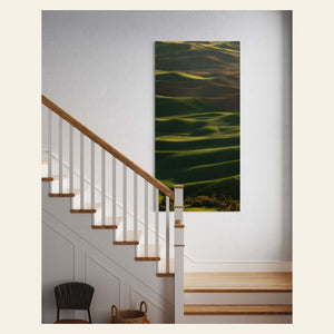 A fine art nature photography print showing a Palouse picture hangs in an entryway.