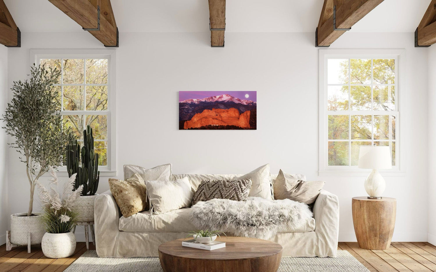 A piece of Colorado art showing a photo of Pike's Peak and the Garden of the Gods in Colorado Springs hangs in a living room.