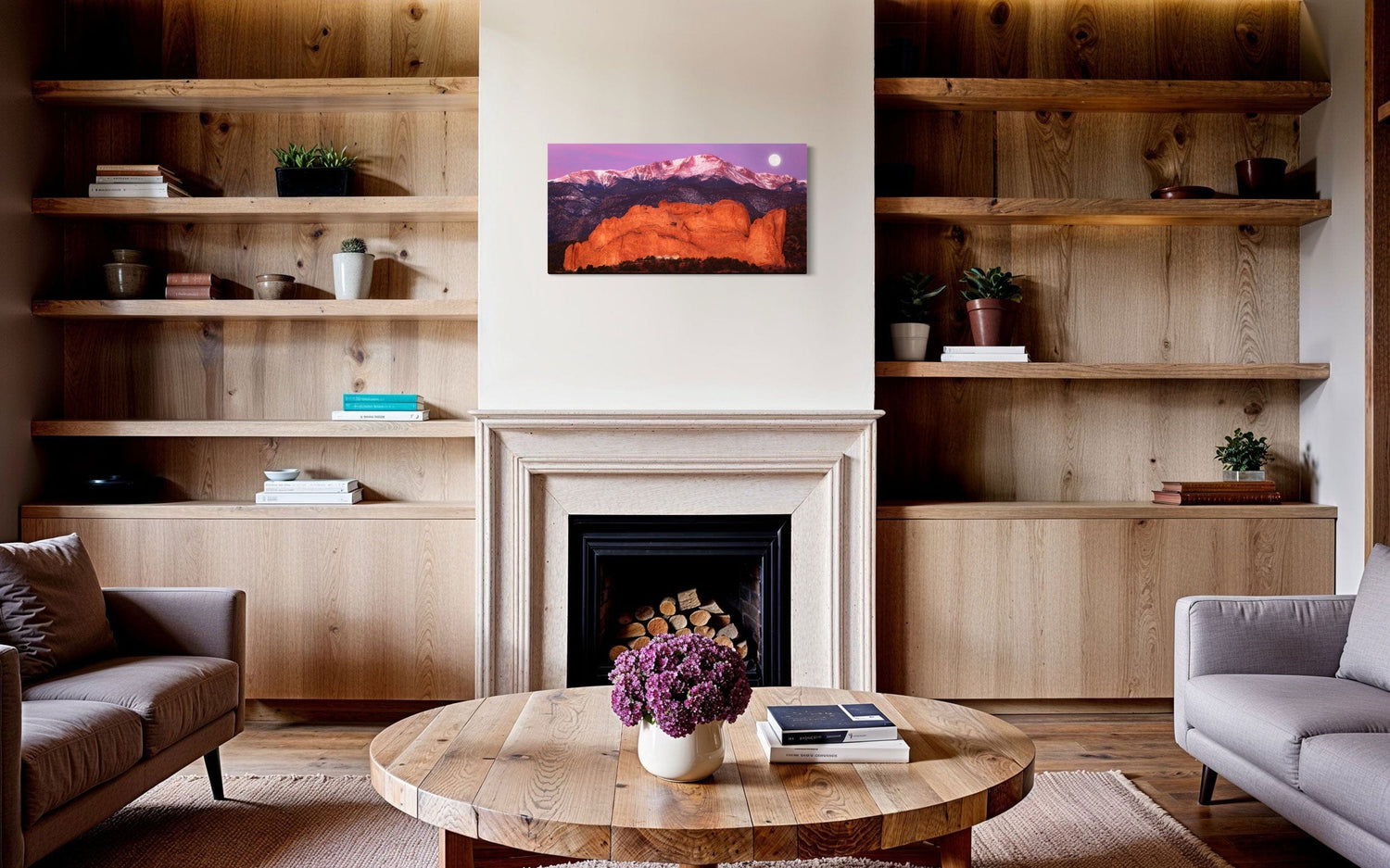 A piece of Colorado art showing a photo of Pike's Peak and the Garden of the Gods in Colorado Springs hangs above a beautiful midcentury modern fireplace.