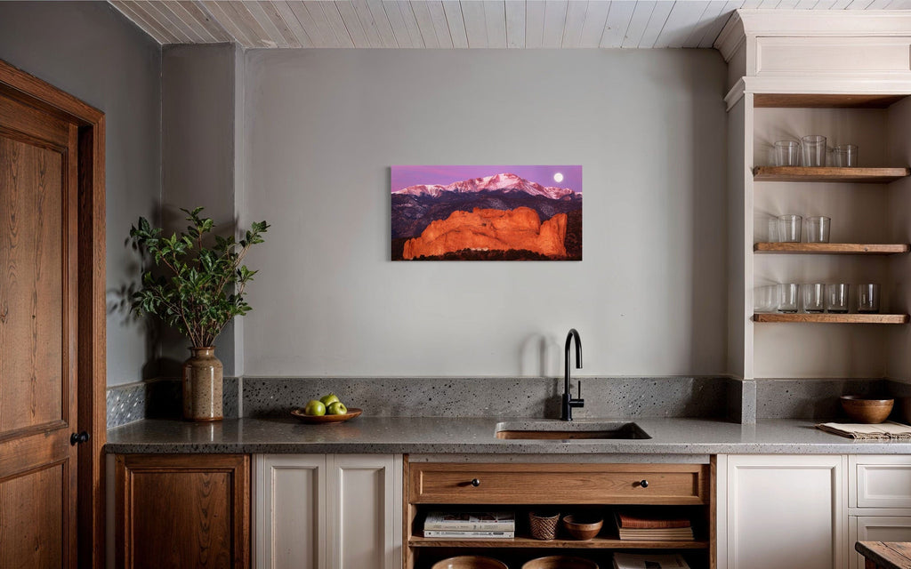 A piece of Colorado art showing a photo of Pike's Peak and the Garden of the Gods in Colorado Springs hangs in a kitchen.