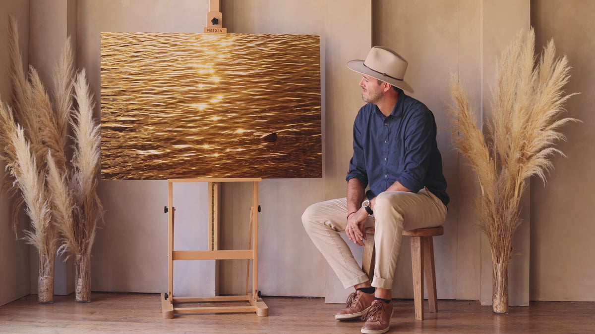 West Seattle artist Lars Gesing shows his Kauai artwork of a Kapaa sunrise getting reflected on the ocean.