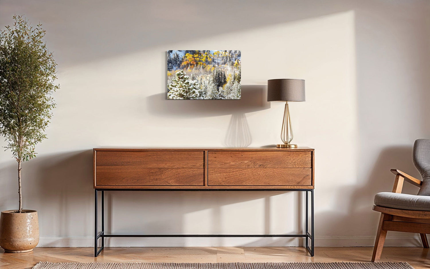 A piece of Rocky Mountain National Park art showing yellow aspen trees after snow in fall hangs in a sitting area.