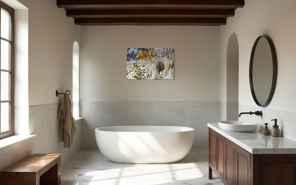 A piece of Rocky Mountain National Park art showing yellow aspen trees after snow in fall hangs in a bathroom.