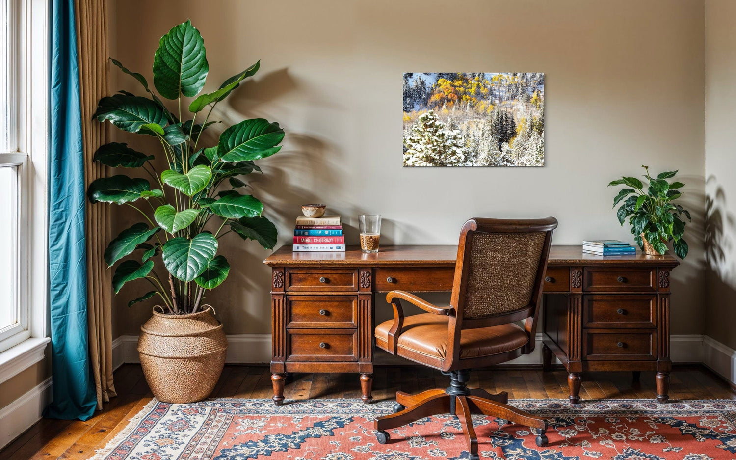 A piece of Rocky Mountain National Park art showing yellow aspen trees after snow in fall hangs in an office.