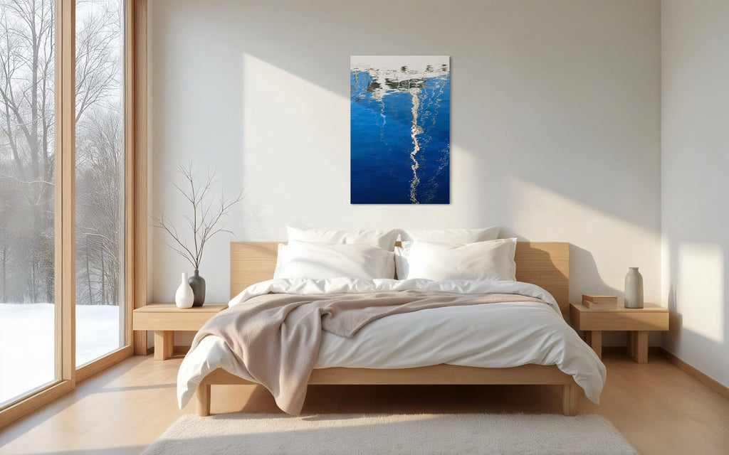 An abstract photo of a sailboat being reflected in the blue water of the San Francisco Marina hangs in a bedroom. | Lars Gesing Fine Art | Nautical Wall Art