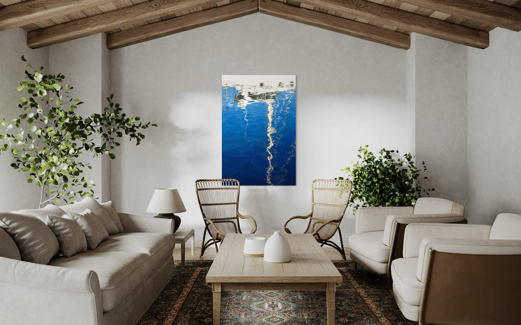 An abstract photo of a sailboat being reflected in the blue water of the San Francisco Marina hangs in a sitting area. | Lars Gesing Fine Art | Nautical Wall Art