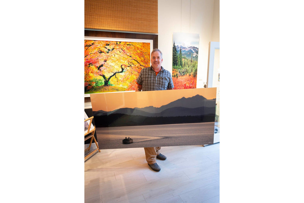 A Lars Gesing art collector poses with a piece of Seattle art.