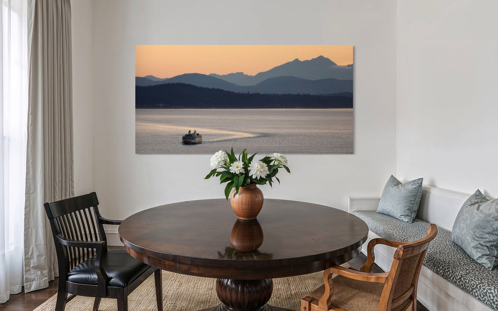 A piece of PNW art showing a Seattle ferry hangs in a dining room.