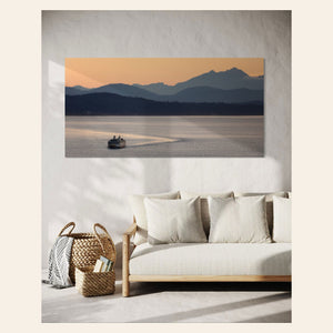 A piece of Seattle wall art photography showing a ferry approaching hangs in a living room.