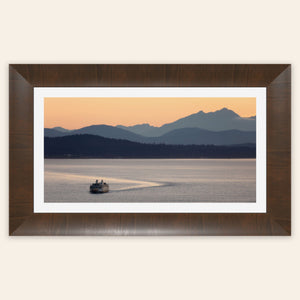 A piece of framed Seattle wall art photography shows a ferry approaching.