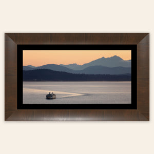 A piece of framed Seattle wall art photography shows a ferry approaching.