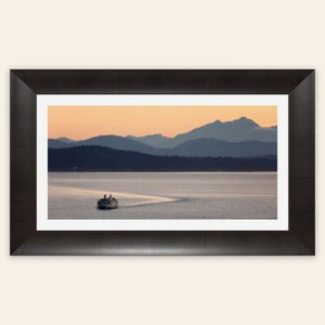 A piece of framed Seattle wall art photography shows a ferry approaching.