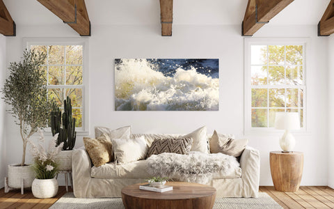 A Shark Fin Cove picture of waves near Big Sur, California hangs in a living room.