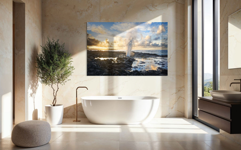 A piece of Kauai art showing a Spouting Horn photo hangs in a bathroom.